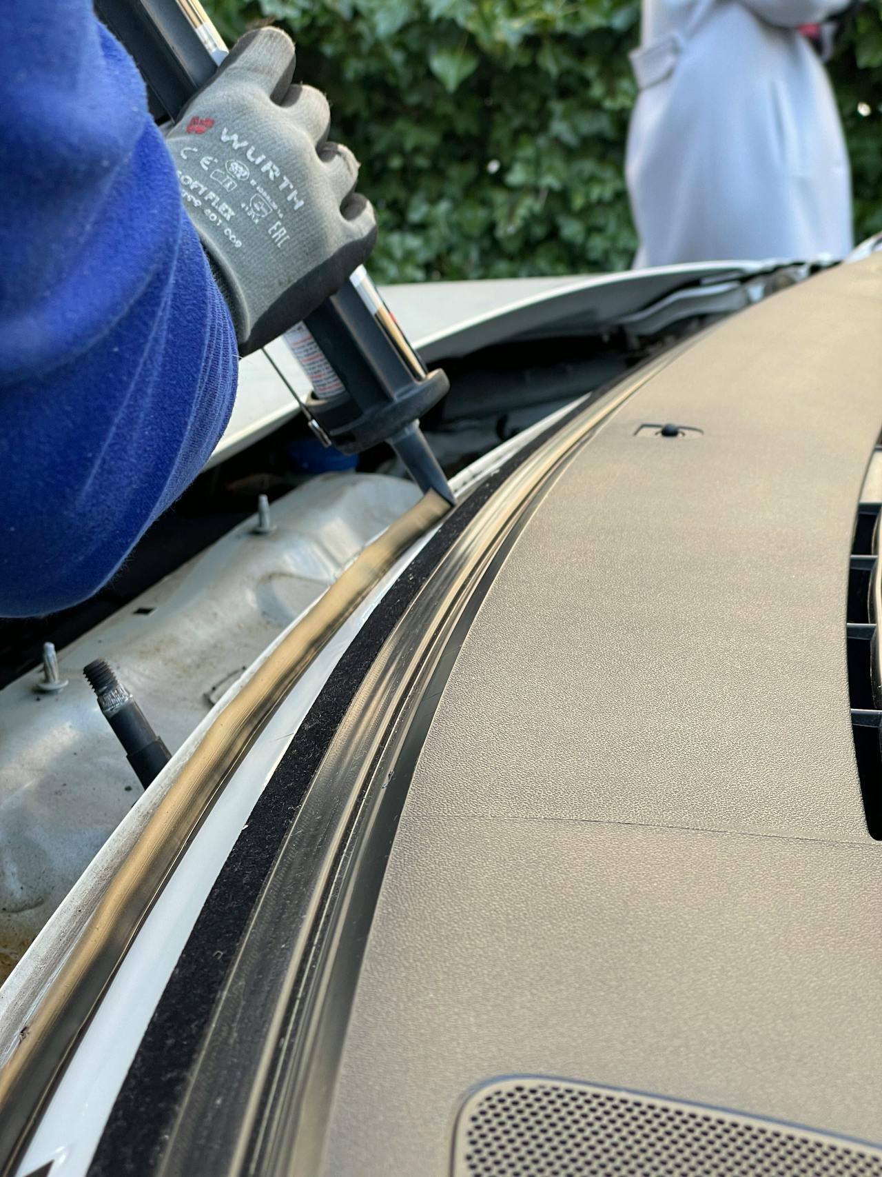 Auto glass technician fitting a replacement windshield