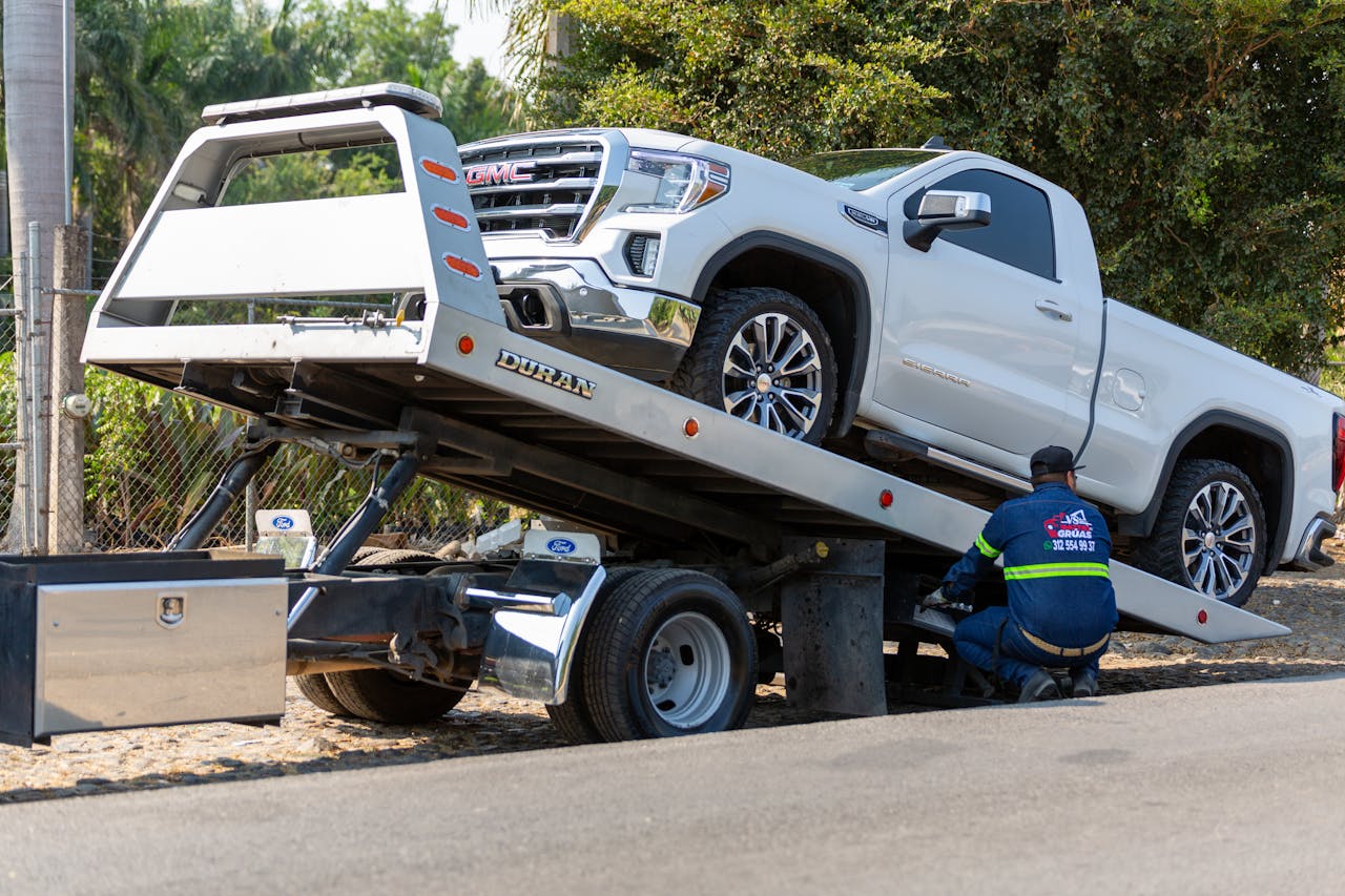 Flatbed tow truck loading a vehicle for transport